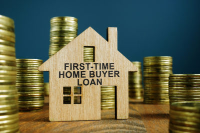 First Time Home Buyer Loan sign on model of house.